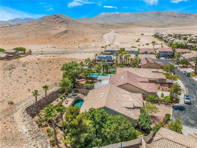 birds eye view of property with a mountain view