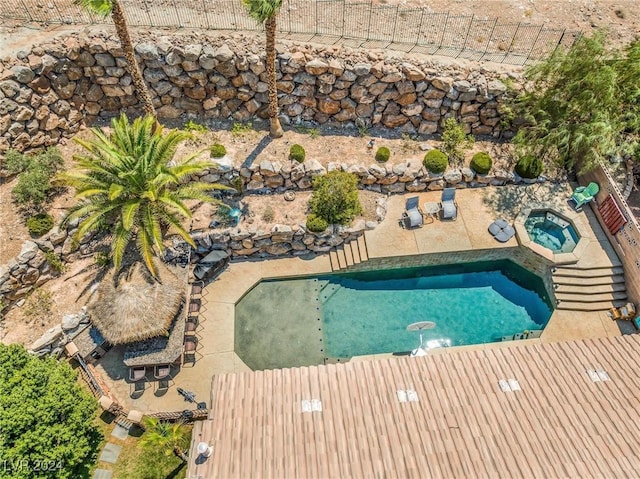 view of pool with an in ground hot tub and a patio