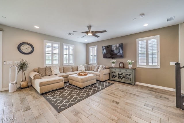 living room with ceiling fan and light wood-type flooring