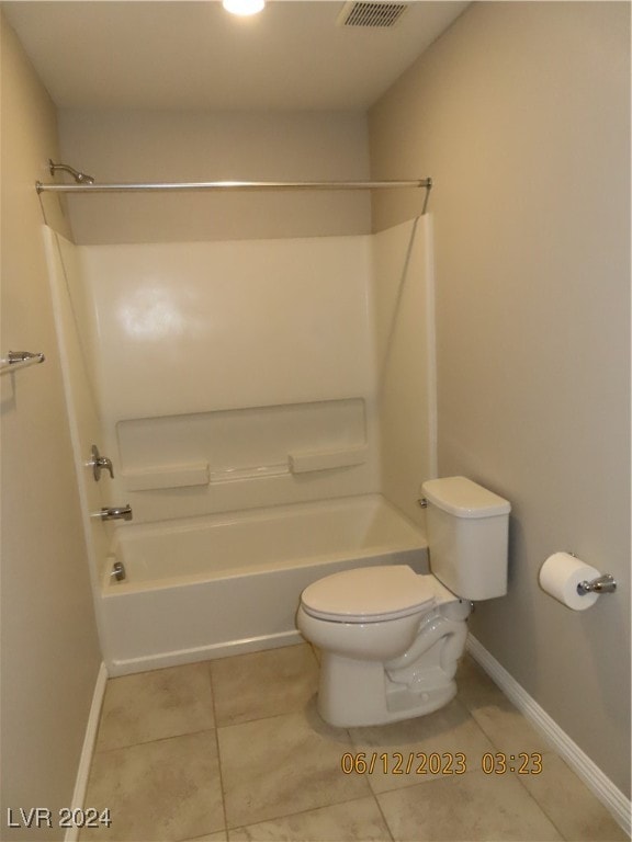 bathroom with shower / bath combination, toilet, and tile patterned flooring