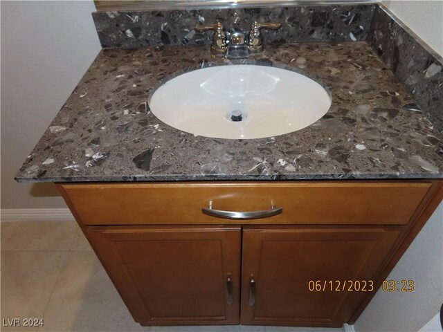 details with tile patterned floors and vanity