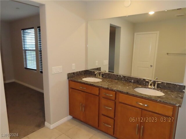 bathroom with tile patterned floors and double vanity