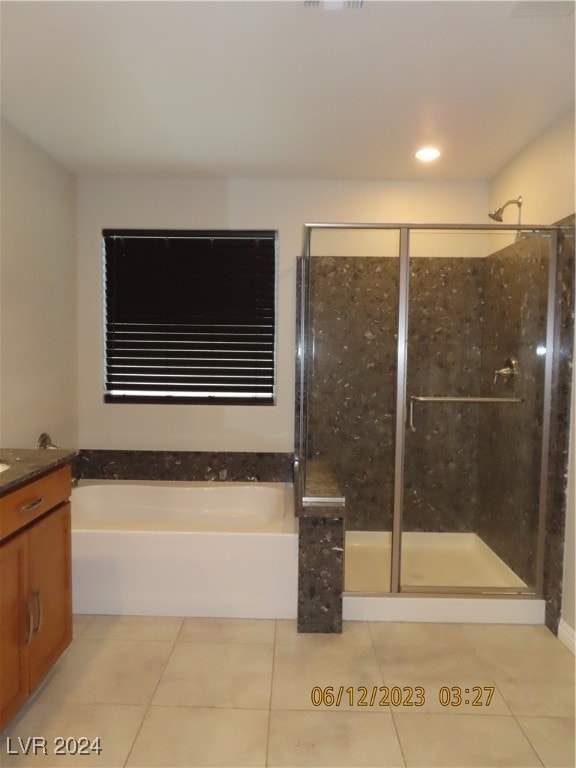 bathroom with independent shower and bath, vanity, and tile patterned floors