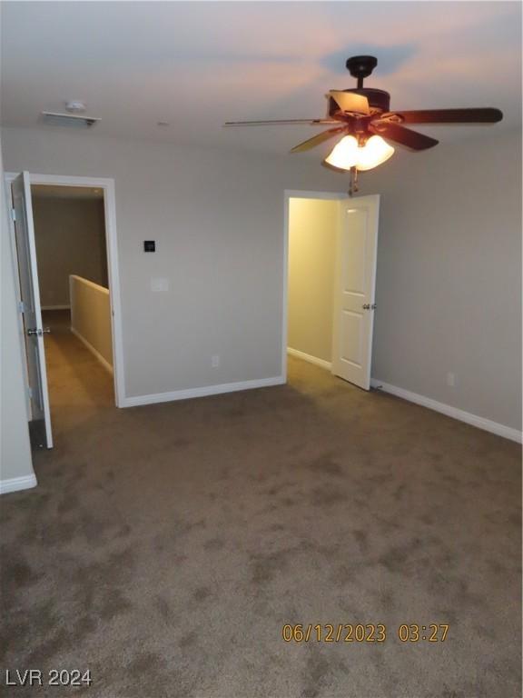 carpeted empty room with ceiling fan