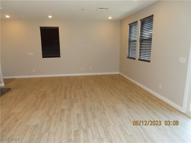 unfurnished room with light wood-type flooring