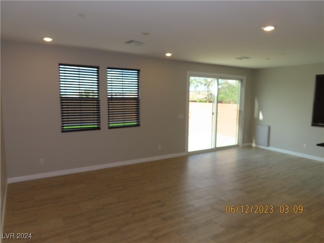 empty room with hardwood / wood-style floors