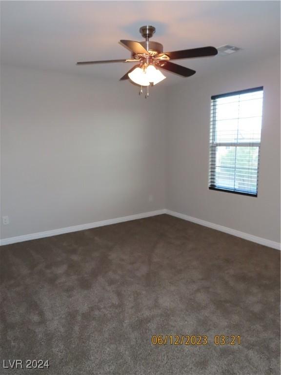 carpeted spare room with ceiling fan