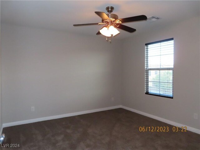 carpeted spare room with ceiling fan