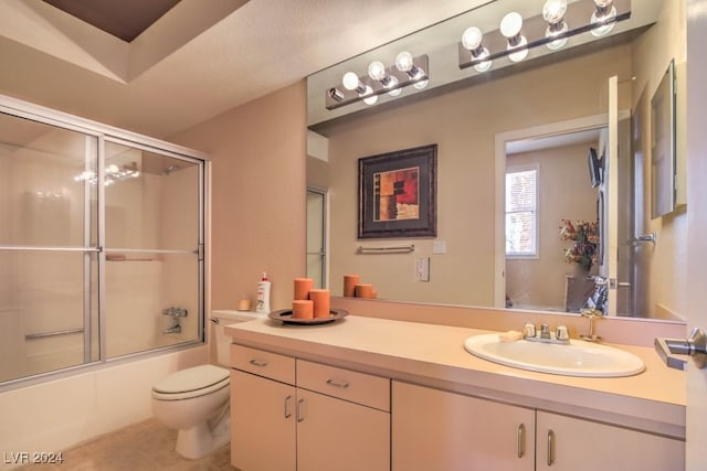 full bathroom with vanity, combined bath / shower with glass door, and toilet