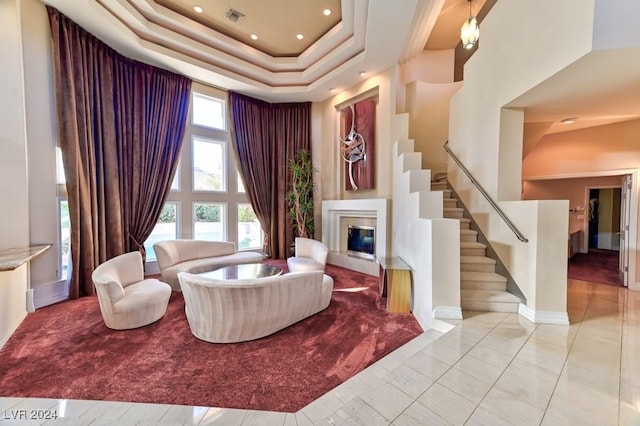 living room with a raised ceiling and a high ceiling