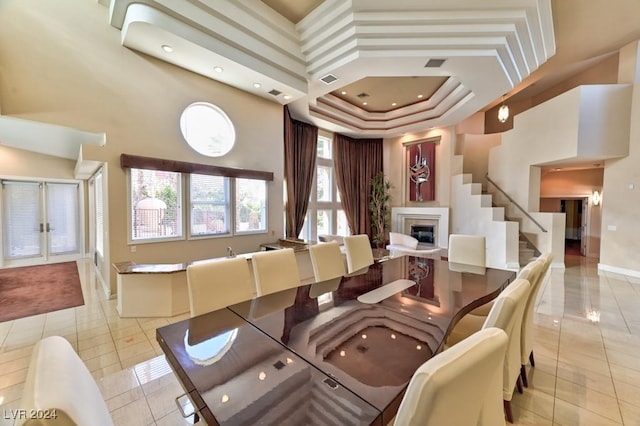 tiled dining room featuring a tray ceiling