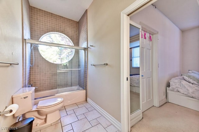 bathroom with shower / bath combination with glass door and toilet