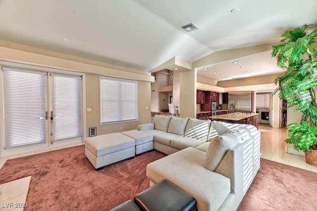 carpeted living room with vaulted ceiling