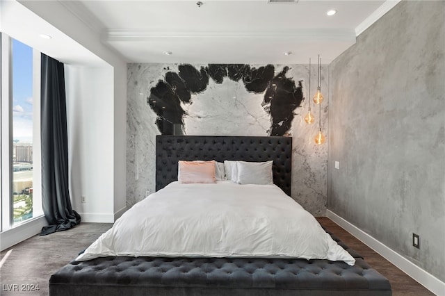 bedroom with ornamental molding, dark wood finished floors, and baseboards