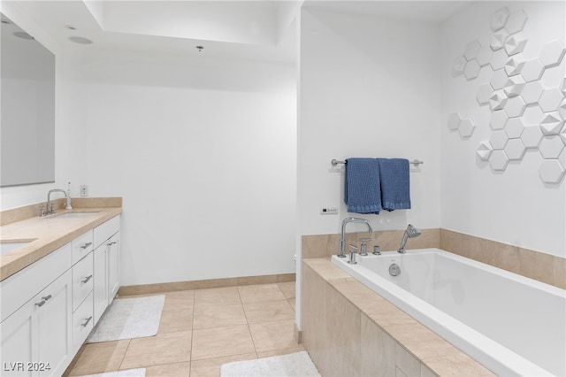 bathroom featuring double vanity, baseboards, tile patterned floors, a garden tub, and a sink