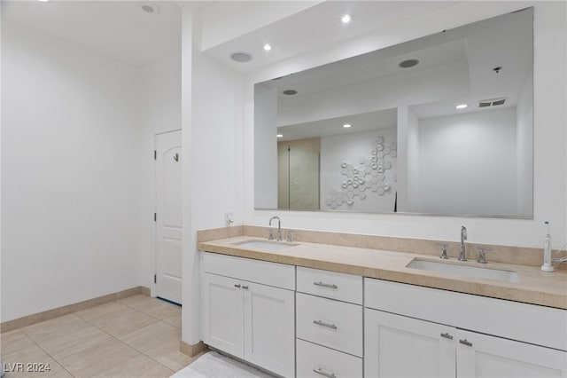 bathroom featuring double vanity, visible vents, a sink, and tile patterned floors