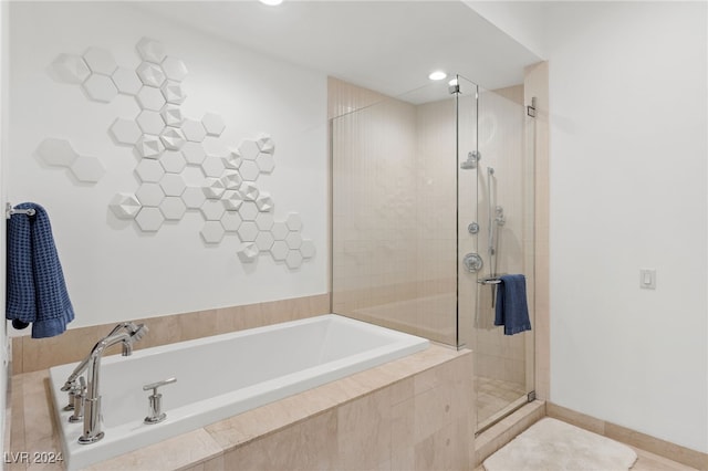 bathroom with a stall shower, baseboards, a garden tub, and recessed lighting