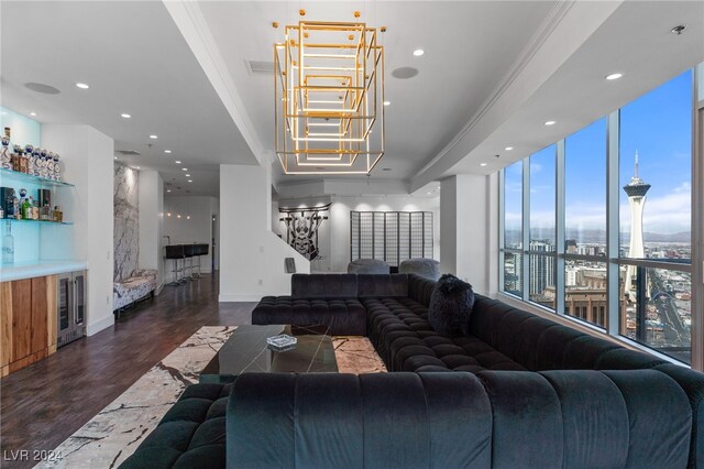 living room featuring a tray ceiling, ornamental molding, a wall of windows, and dark hardwood / wood-style flooring