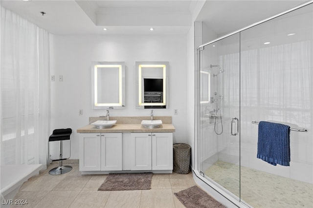 full bathroom with double vanity, tile patterned flooring, a sink, and a shower stall