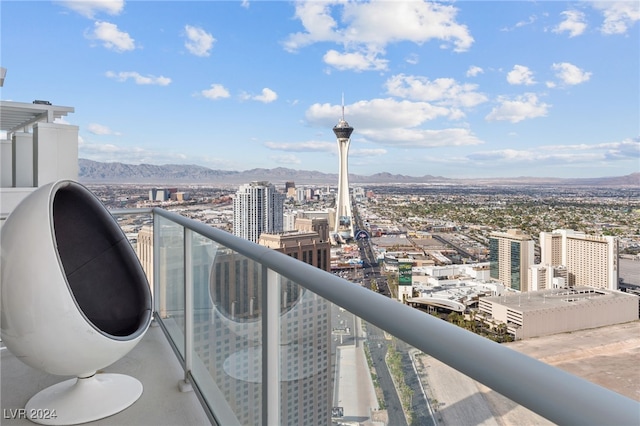 balcony featuring a mountain view and a city view