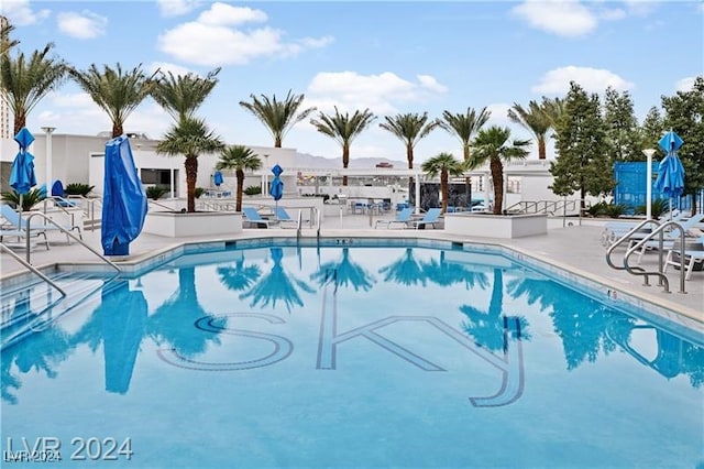 community pool featuring a patio area and fence