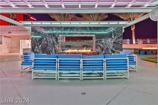 view of patio featuring an outdoor living space with a fireplace