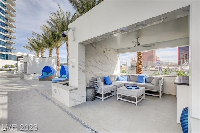 view of patio / terrace with a city view, ceiling fan, and an outdoor hangout area