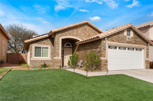 view of front of property with a garage and a front lawn