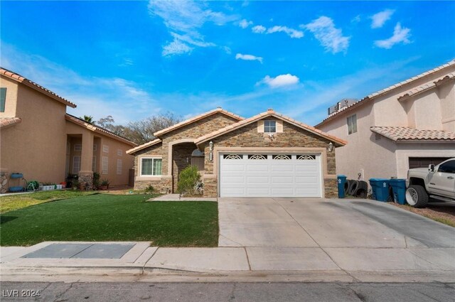 view of front of home with a garage and a front lawn