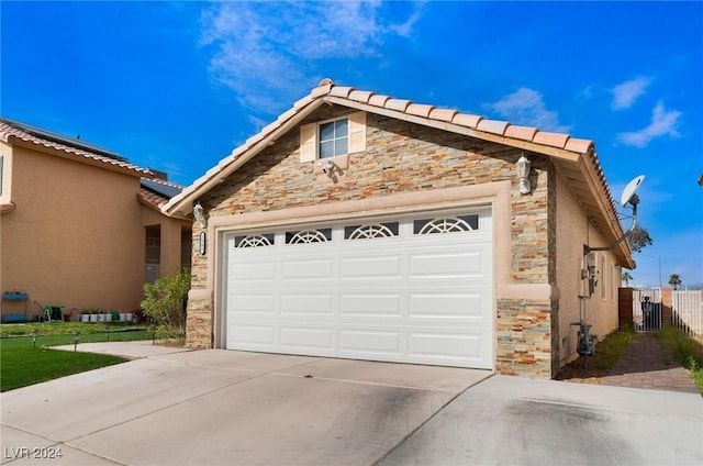 exterior space with a garage and central AC