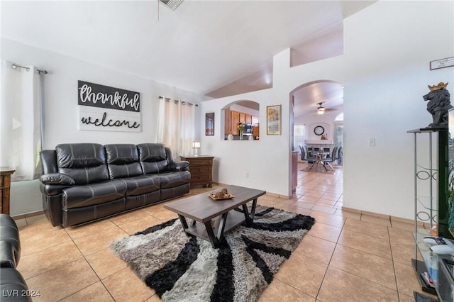 tiled living room with lofted ceiling and ceiling fan