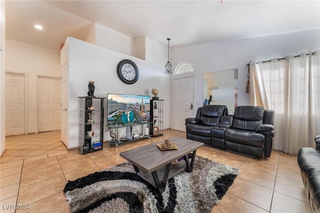 tiled living room with high vaulted ceiling