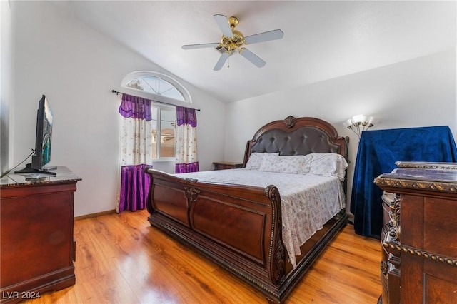 bedroom featuring ceiling fan, lofted ceiling, and light wood-type flooring