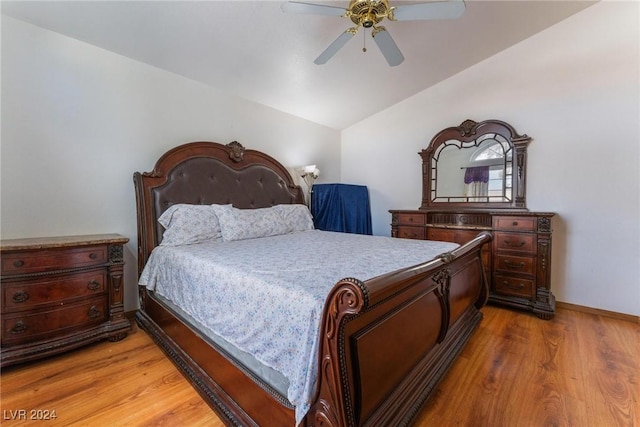 bedroom with hardwood / wood-style flooring, vaulted ceiling, and ceiling fan