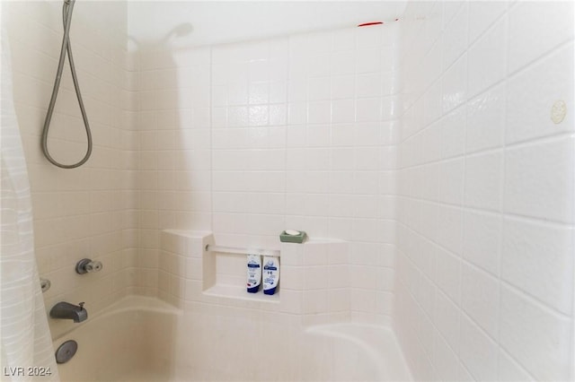 bathroom with shower / tub combo with curtain