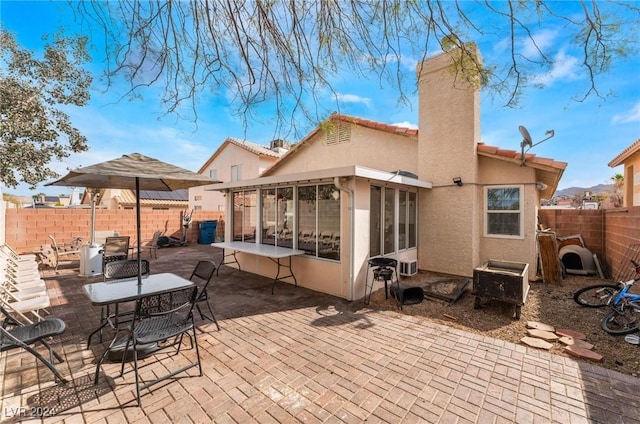 back of house featuring a patio and a sunroom