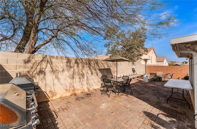 view of patio featuring an outdoor kitchen and a grill