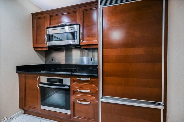 kitchen featuring stainless steel appliances and light tile patterned floors