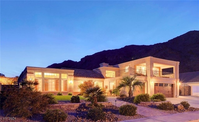 view of front of house with a balcony and a mountain view