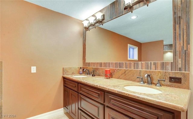 bathroom featuring vanity and backsplash