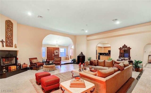 living room with tile patterned flooring and a premium fireplace