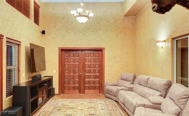 living room with a high ceiling and a notable chandelier