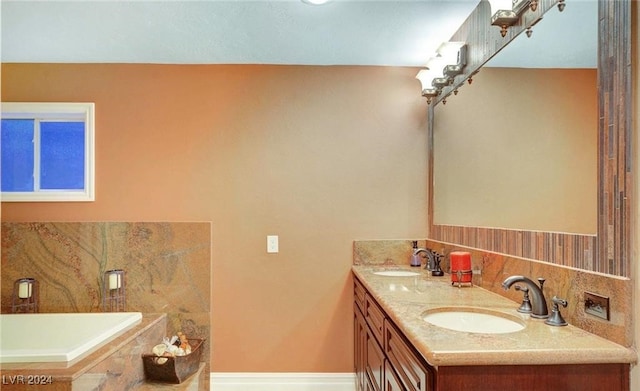 bathroom with vanity and a tub to relax in