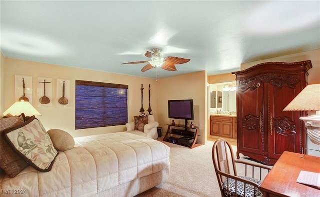 bedroom with ceiling fan, light colored carpet, and ensuite bathroom