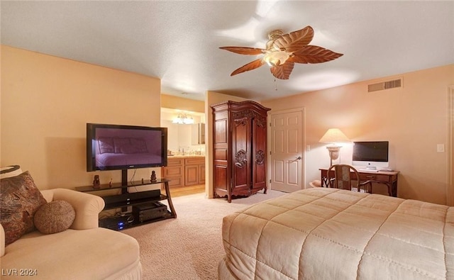 carpeted bedroom featuring ceiling fan and ensuite bathroom