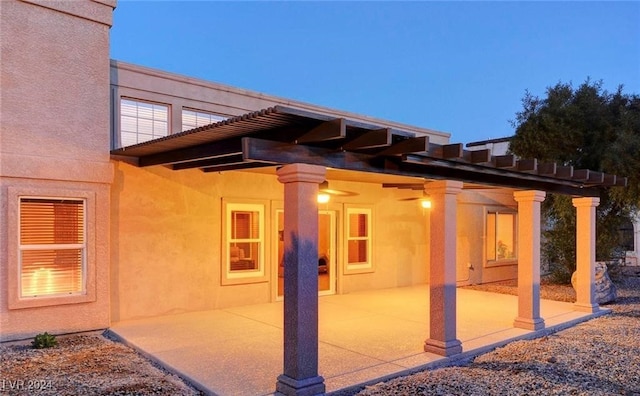 back house at dusk with a patio