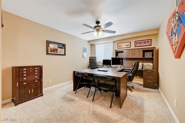 carpeted home office with ceiling fan