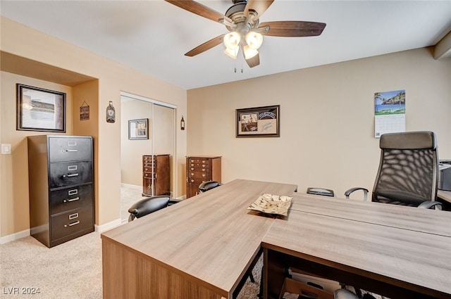 carpeted office featuring ceiling fan