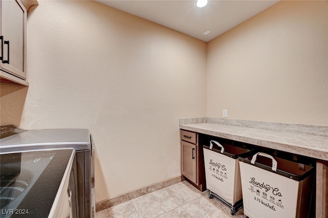 kitchen featuring light tile patterned floors and washing machine and clothes dryer