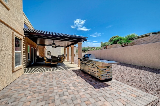 view of patio featuring ceiling fan and exterior kitchen